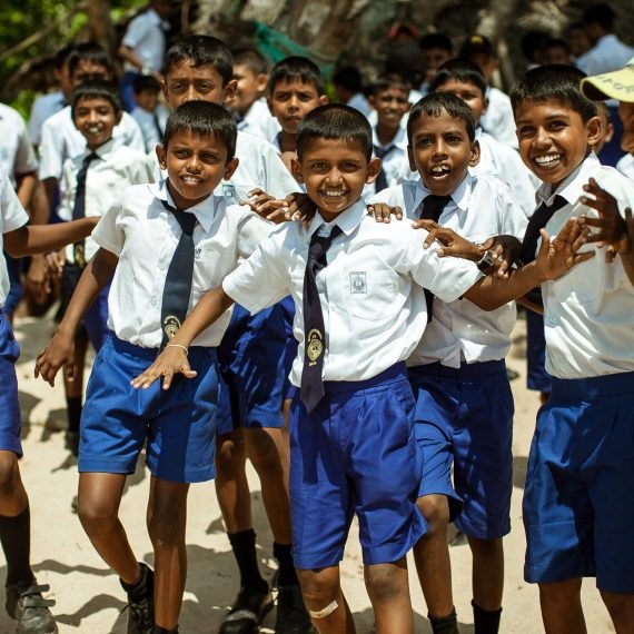 School children dressed in uniform have fun and play in the schoolyard. Wadduwa, Sri-Lanka.